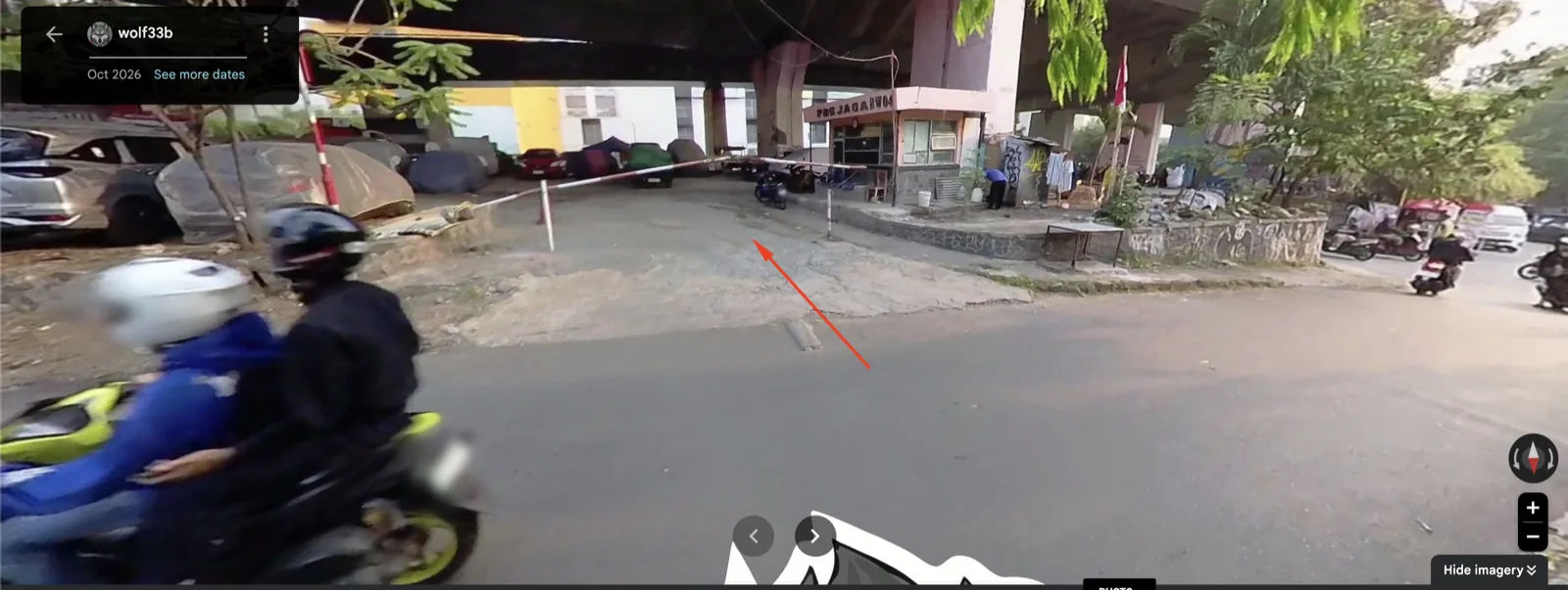 Street View: the car park entrance beside the guard post, marked with a red arrow.