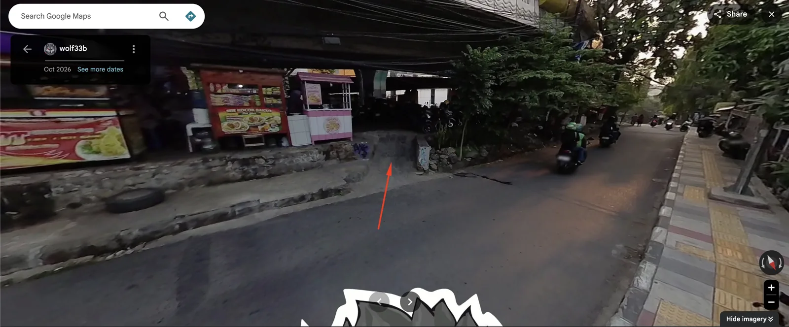 Street View: the pedestrian and motorbike gap between the food stalls, marked with a red arrow.
